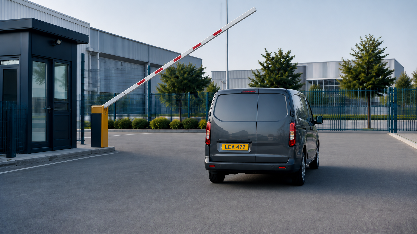 Vehicle entering a factory gate with a visible fictional number plate